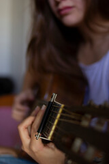 Girl Playing Guitar at Home