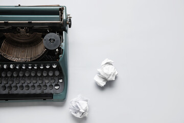Vintage typewriter with crumpled paper on white background