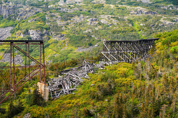 Collapsed trestles railroad bridge in the White Pass and Yukon Route gorge between Skagway, Alaska and the Canadian border
