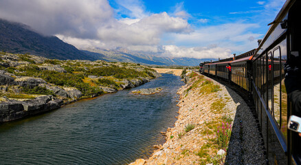 Narrow-gauge train of the White Pass and Yukon Route in the Alaskan mountains between Skagway and...