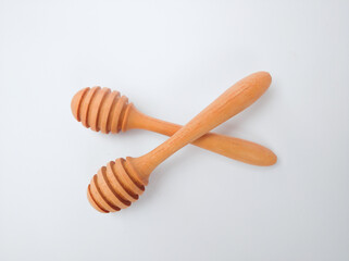 Wooden honey spoon isolated on white background