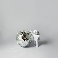 Disco ball and astronaut. Party concept. Square banner. Selective focus, copy space