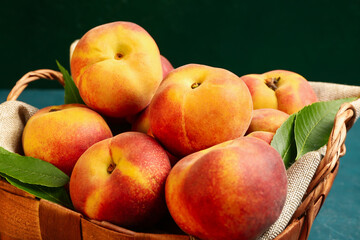 Wicker basket with sweet peaches, closeup
