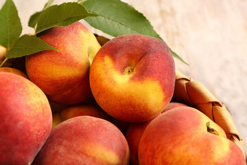 Many sweet peaches and leaves, closeup