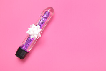 Vibrator with beautiful bow on pink background