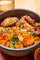 angle view Korean chicken bibimbap with cup of coffee at vertical composition