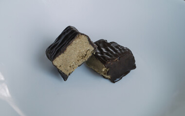 A piece of halva. Halva in chocolate. Halvah, challah