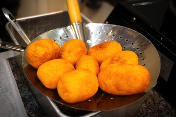 Jemblem, a traditional sweet croquette from Java, is made from cassava with butter and flour. Cooked in hot oil and fried, then dried on a bamboo tray. It is round and tastes sweet. close-up view.