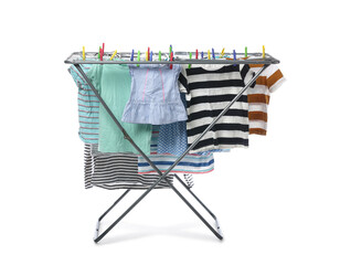 Dryer with children's clothes isolated on white background