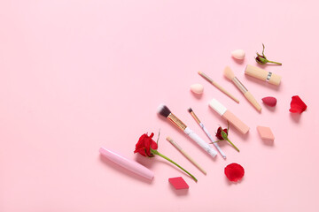 Composition with makeup products and beautiful red rose flowers on pink background