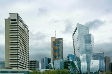 Fototapeta na wymiar View of modern skyscrapers in city on cloudy day