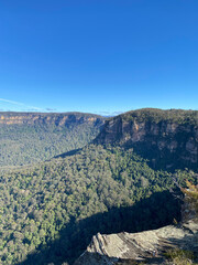 Spectacular views from a mountain-top lookout. Mountains in the horizon. Blue mountains, Australia, NSW. Unusual rock formation. Summit of the mountain.