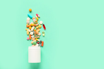 Composition with bottle and pills on color background
