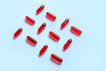 Composition with red capsules on color background