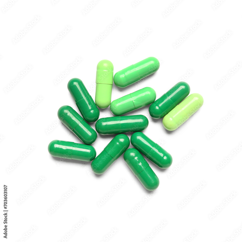 Wall mural Green capsules isolated on white background