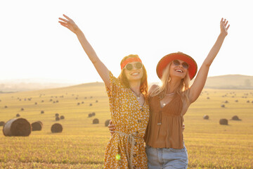 Portrait of beautiful happy hippie women in field