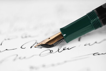Writing letter with elegant fountain pen, closeup