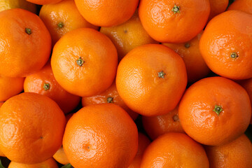Delicious fresh tangerines as background, top view