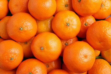 Delicious fresh tangerines as background, top view