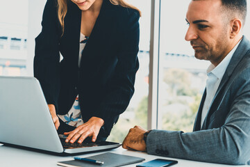 Businessman executive is in meeting discussion with a businesswoman worker in modern workplace office. People corporate business team concept. uds