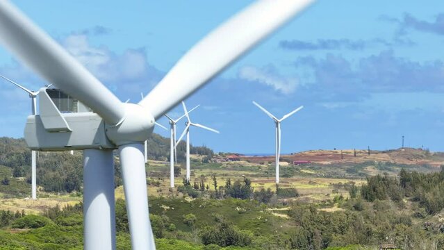 Windmills aerial view on sunny summer day on Hawaii. Renewable energy concept. Wind energy technology 4K. Climate change efforts concept b roll USA. Cinematic wind power plant on tropical Oahu Island