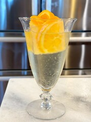 Orange Ice Cube with Champagne Bubbles in a Glass