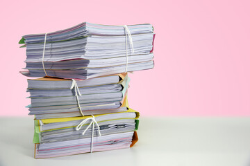 Pile or heap of financial business document paperwork stack on office desk concept of workload...