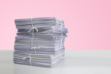 Pile or heap of financial business document paperwork stack on office desk concept of workload...