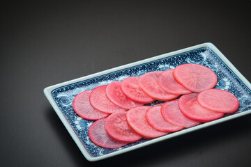 Purple radish sliced into rounds and dipped in sweet vinegar, with a beautiful coloring.