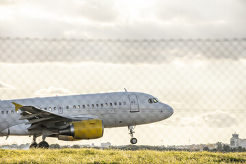 A passenger plane landing with smoke from burning rubber