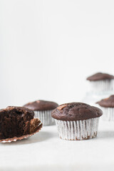 Double chocolate muffins on a white marble tray, dark chocolate muffins with a white background