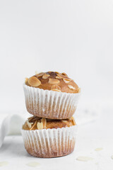 muffins on a white marble tray, homemade bakery style almond muffins on a white background