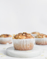 Obraz na płótnie Canvas almond muffins on a white tray, homemade bakery style almond muffins on a white background