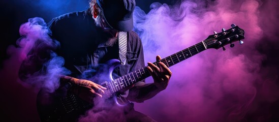 musician playing guitar with purple flare. dark background - obrazy, fototapety, plakaty