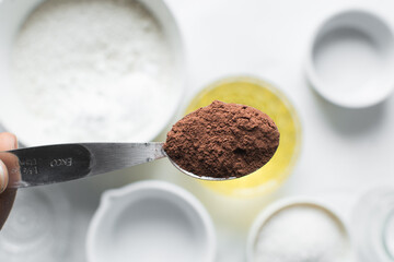 Cocoa powder in a measuring spoon, a tablespoon of cocoa powder