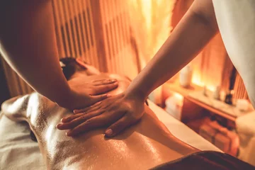 Keuken foto achterwand Massagesalon Closeup woman customer enjoying relaxing anti-stress spa massage and pampering with beauty skin recreation leisure in warm candle lighting ambient salon spa at luxury resort or hotel. Quiescent