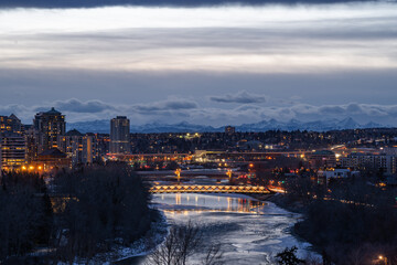 Fototapeta na wymiar Bow River, Calgary Downtown, Rocky Mountains in the Back, The Rockies