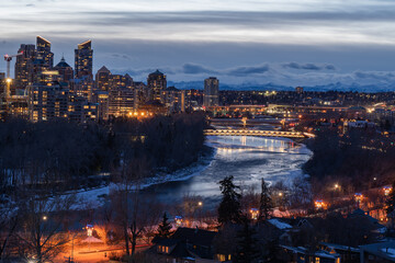 Fototapeta na wymiar Bow River, Calgary Downtown, Rocky Mountains in the Back, The Rockies