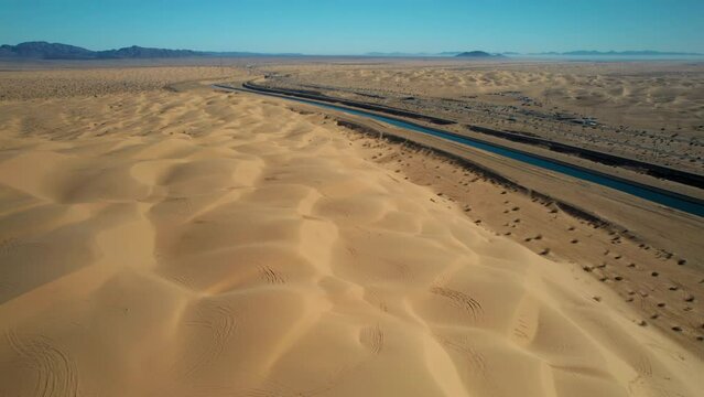 Dramatic aerial view of the all-American canal traveling through the Buttercup sand dunes in imperial county California.