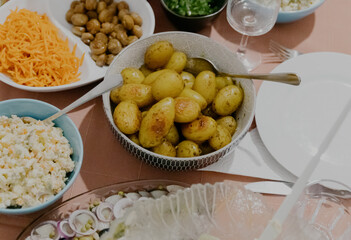 Baked new potatoes in skins on the table.