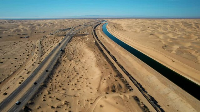 Dramatic aerial view of the all-American canal traveling through the Buttercup sand dunes in imperial county California.