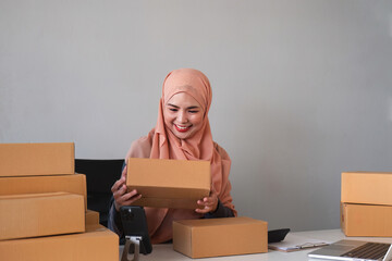Beautiful Muslim woman selling online at home, business owner, business start up small business concepts