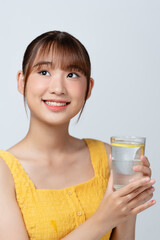 Pleasant woman holding glass of water