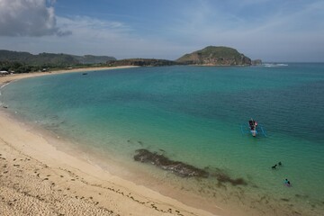 Aerial view of Tanjung Aan beach in Lombok island, West Nusa Tenggara, Indonesia. white sandy beach with turquoise water. tropical beach view. This beach is famous for its waves for surfing.