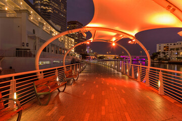 Riverwalk at Night - A wide-angle night view of colorfully illuminated Tampa Riverwalk, winding along side of Hillsborough River, at Downtown Tampa, Florida, USA.