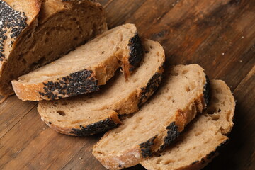 multi-grain whole wheat bread sliced on wooden table.. carbohydrates, high fiber, low calories....