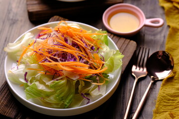 garden salad. romaine lettuce, shaved carrots, purple cabbage, cucumber. olive oil dressing.