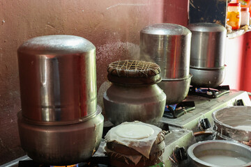 Kerala Indian traditional kitchen cooking or making Idly. Healthy breakfast steamed food. Ramasseri idli near Palakkad Kerala India. 