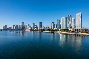 Fototapeta na wymiar City of Miami, Florida reflected in calm water of Biscayne Bay on sunny December morning.