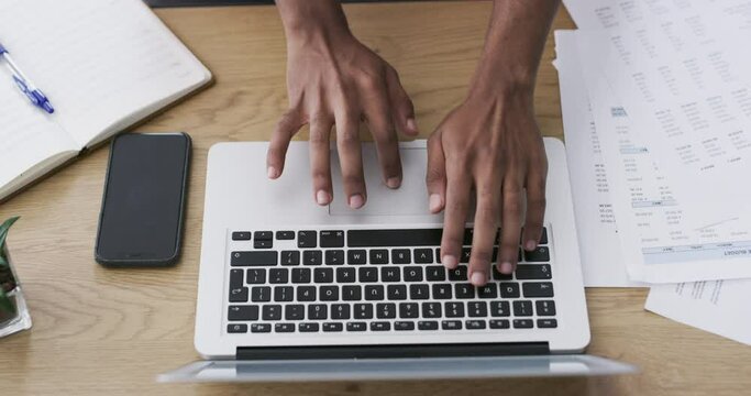 Hands, laptop and documents for finance, accounting and taxes research, management or planning at desk above. Business person typing on computer with paperwork, budget report or project invoice